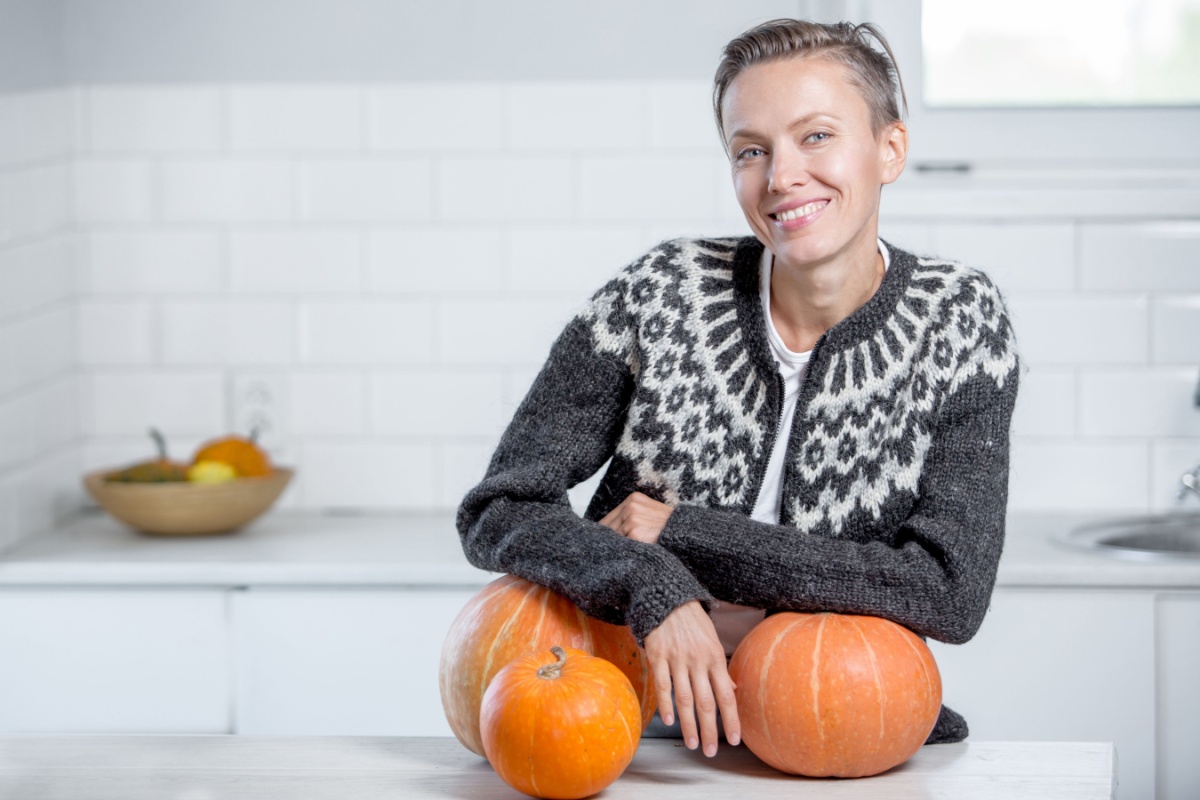 woman with pumpkins in kitchen