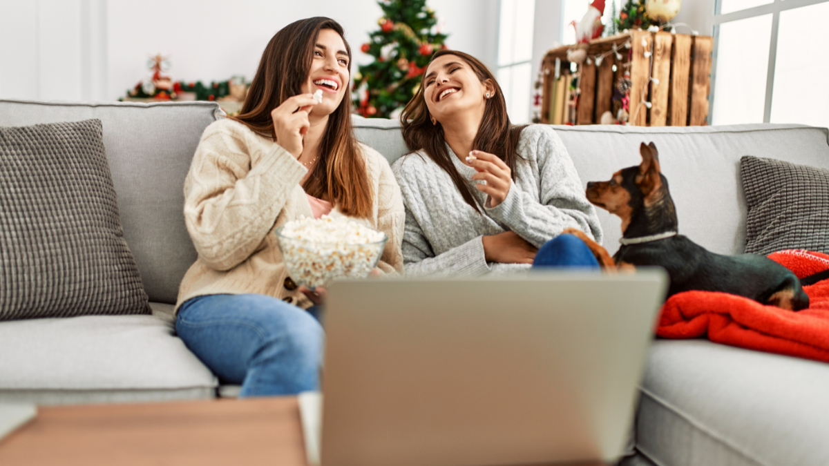 women watching movie with dog