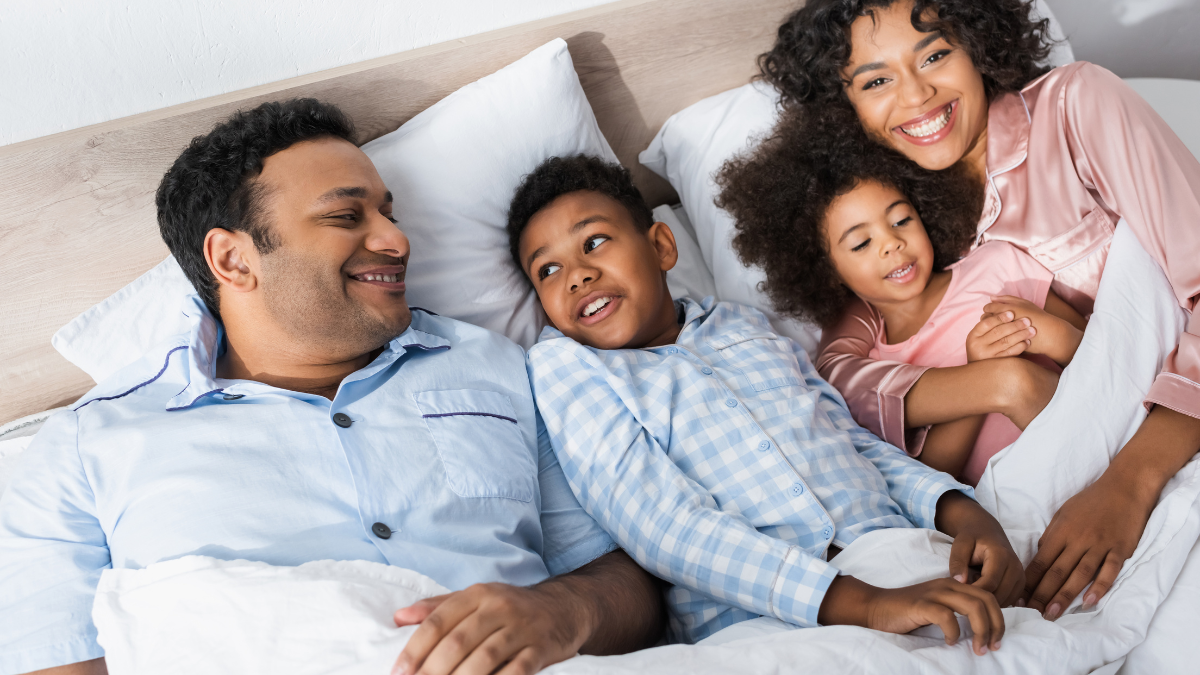 family in pajamas and in bed
