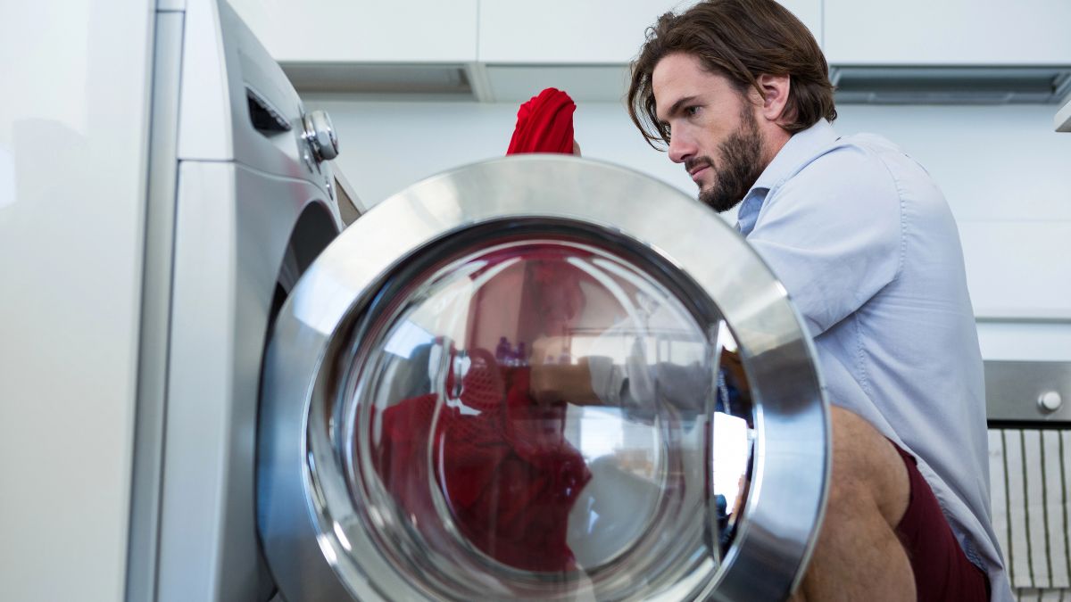 man loading washing machine