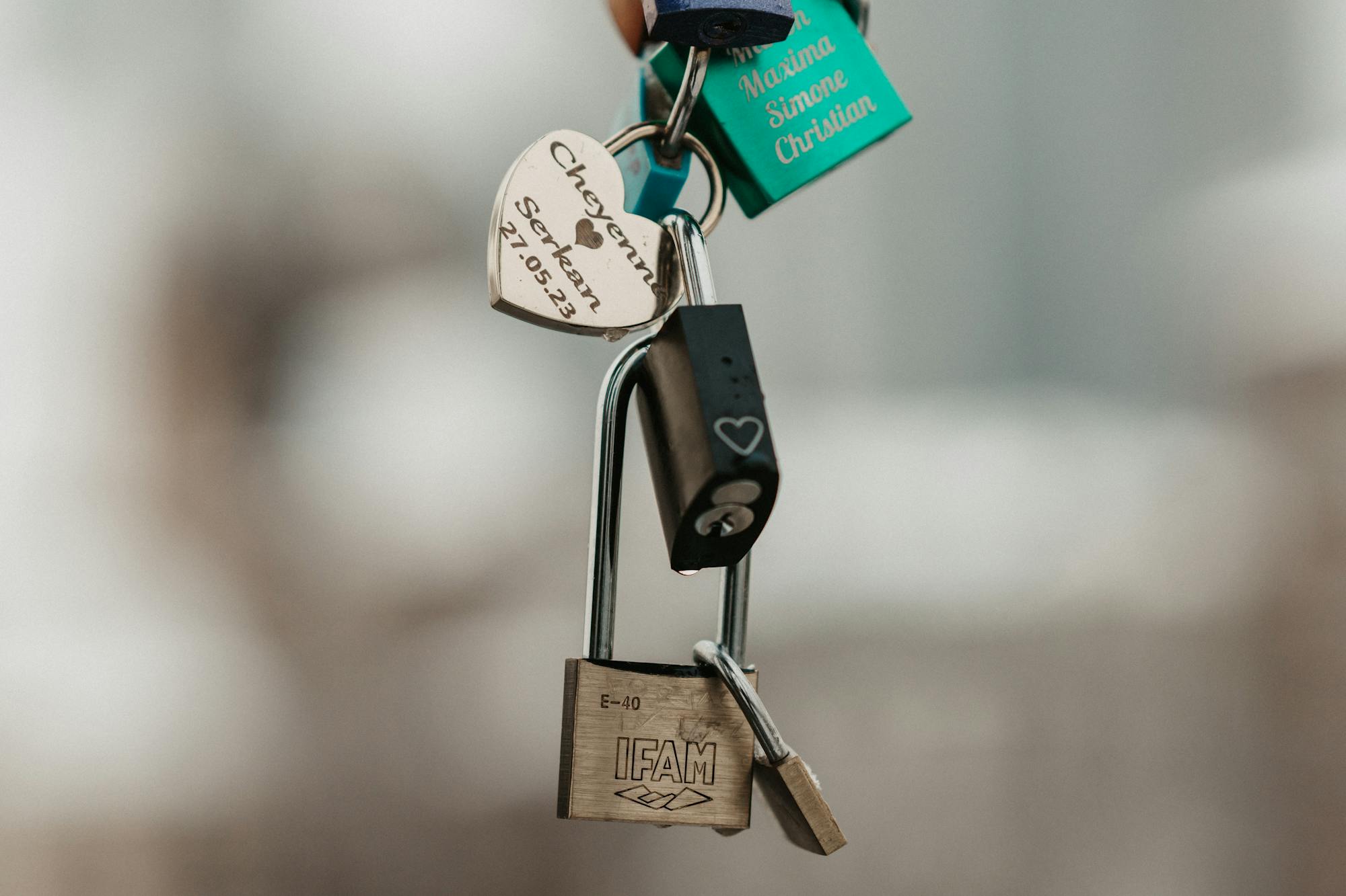 Close-up image of various personalized love padlocks symbolizing commitment and affection.