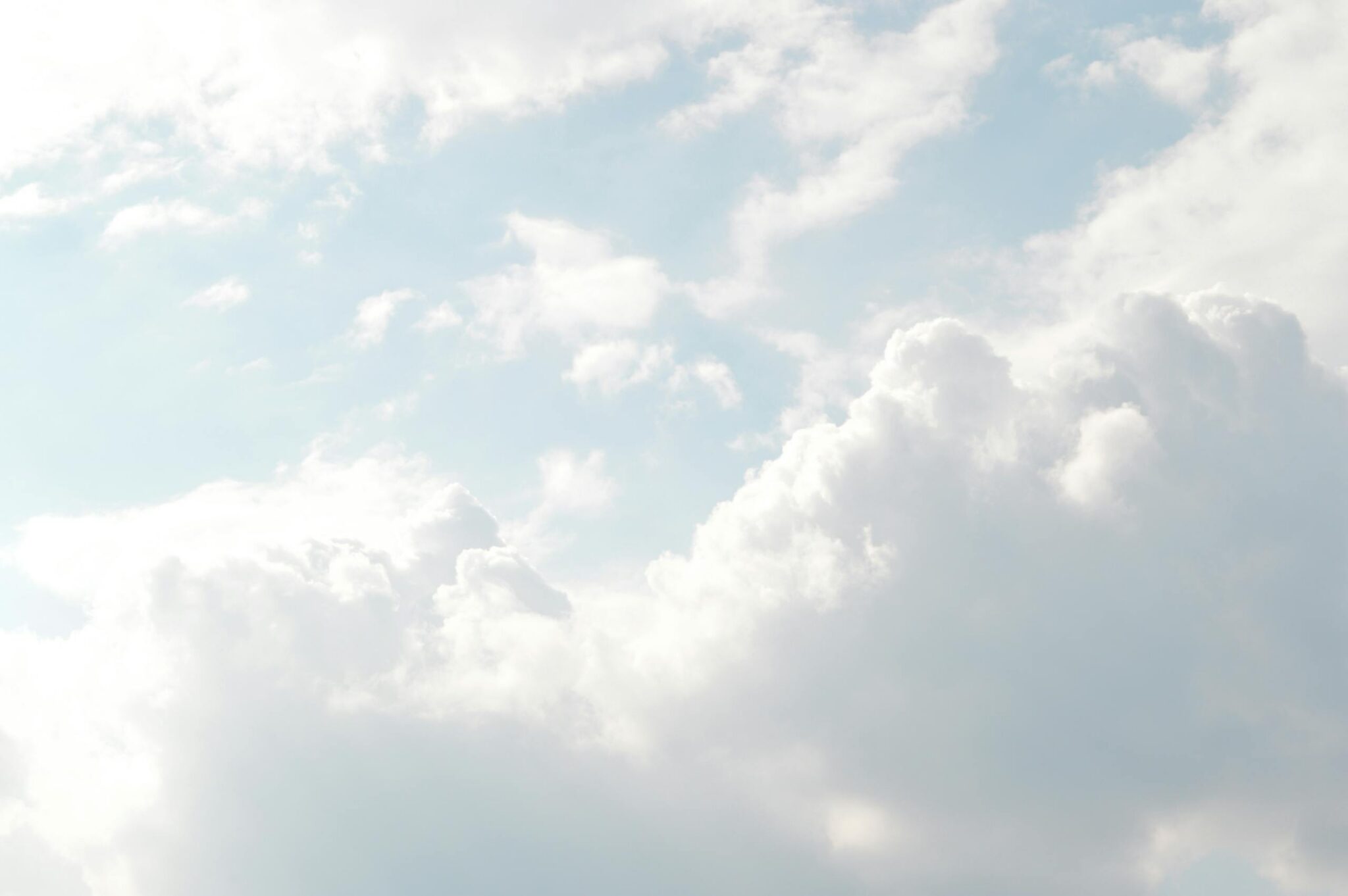 A serene view of thick, fluffy clouds set against a bright blue sky, perfect for backgrounds.